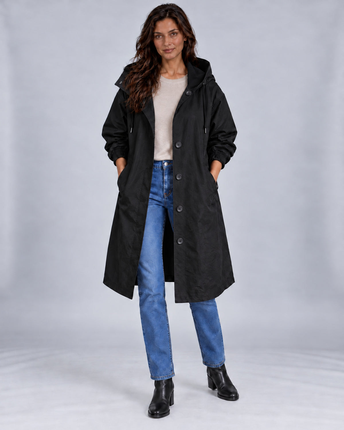 Women's water-repellent hooded trench coat – Black front with both hands in pockets – Andrea