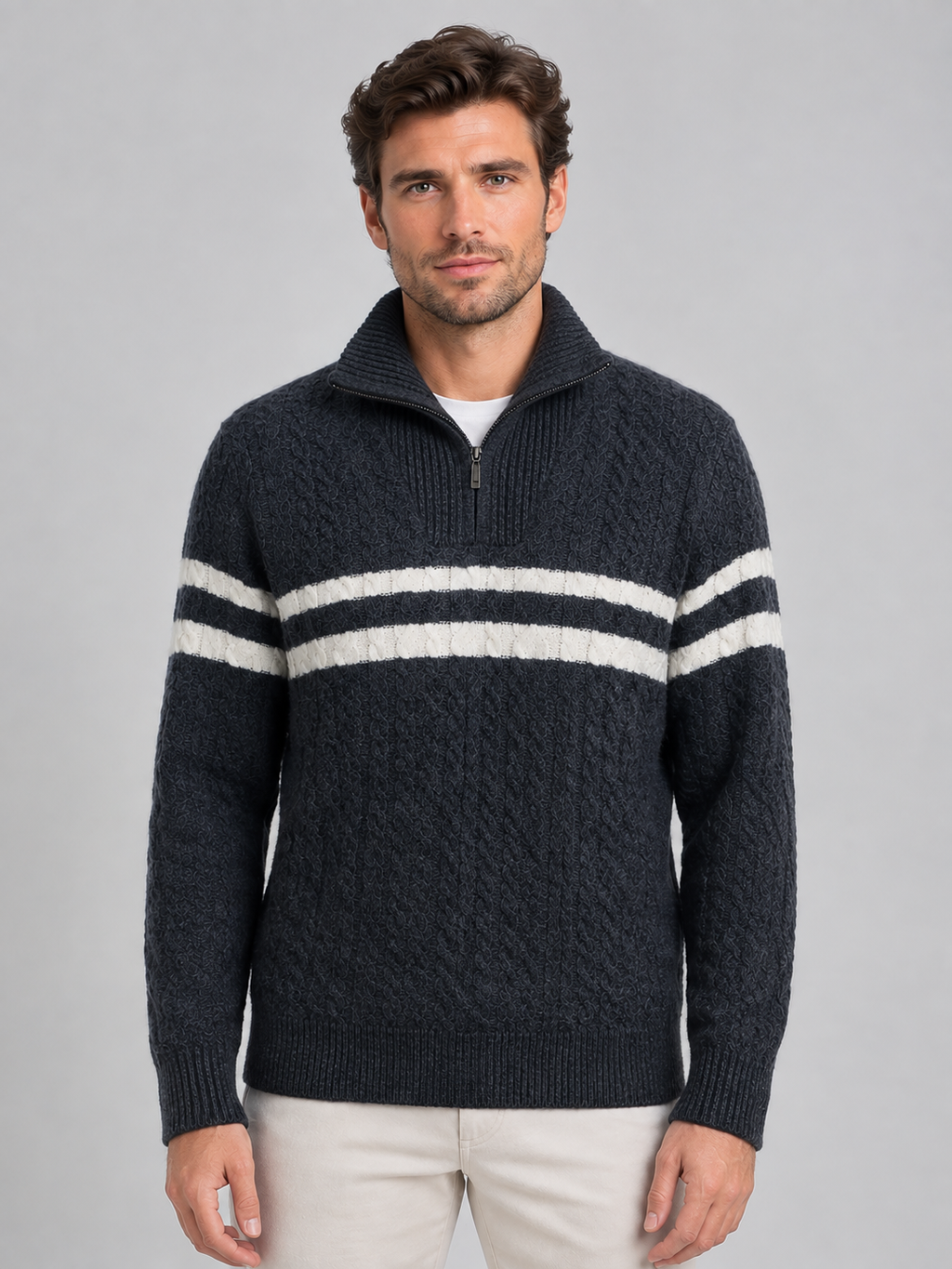 Men's dark gray wool cable knit sweater with white horizontal stripes and half-zip high neck collar, worn with white undershirt