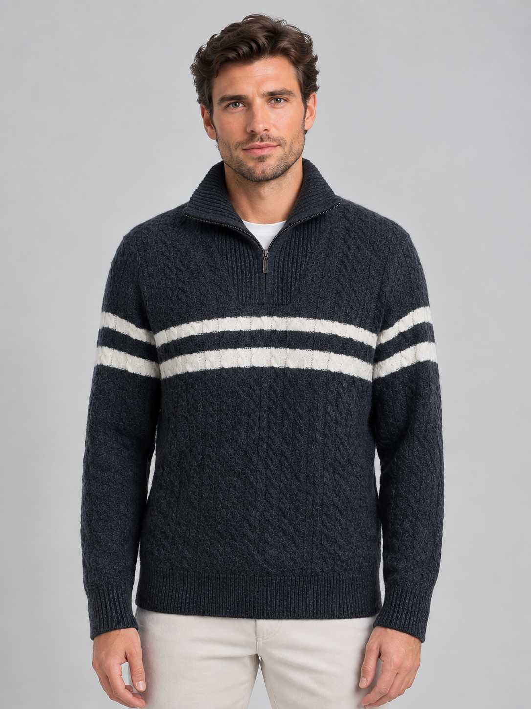 Men's dark gray wool cable knit sweater with white horizontal stripes and half-zip high neck collar, worn with white undershirt