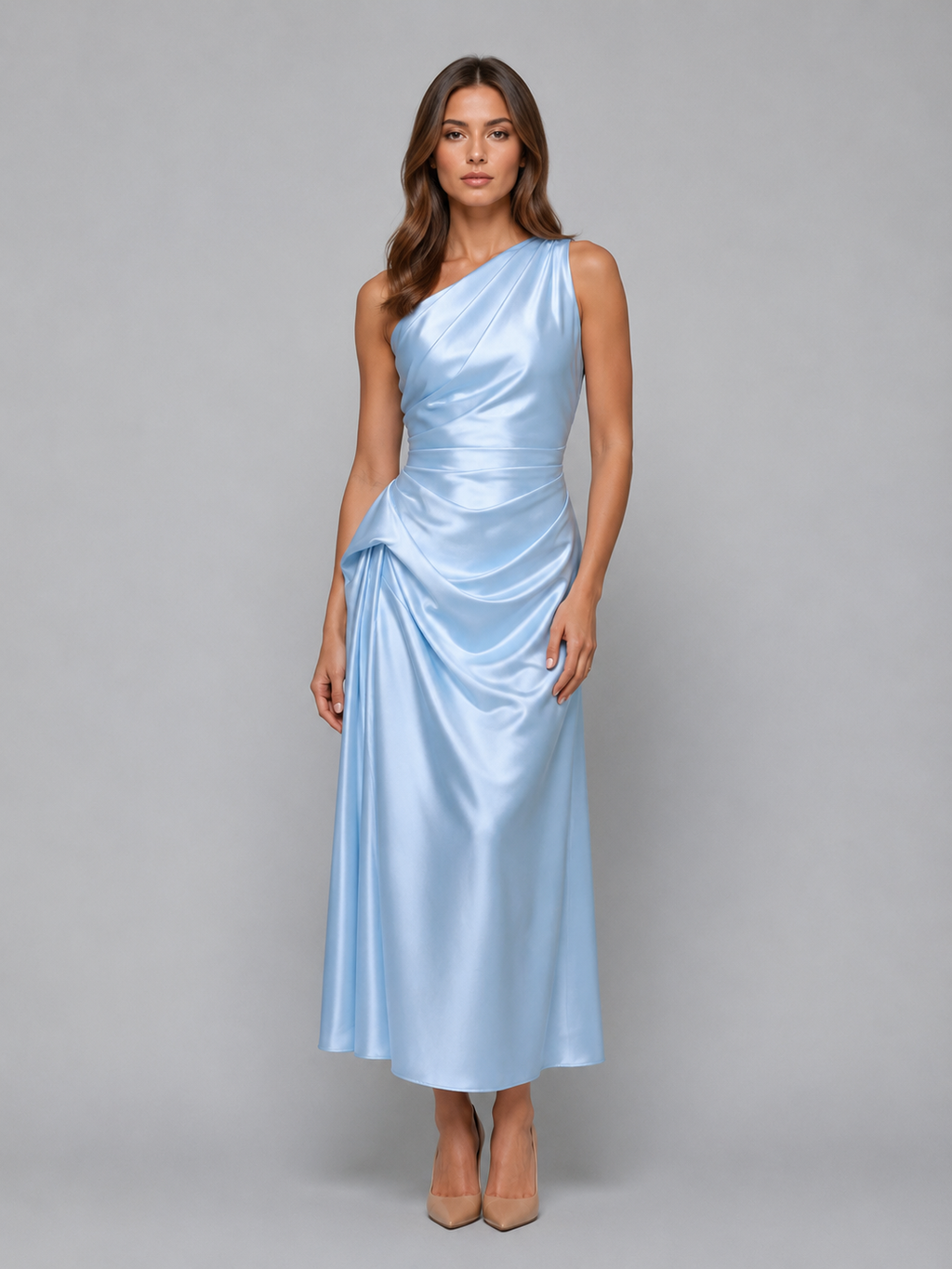 Woman wearing light blue one-shoulder satin midi dress with ruched details and side draping, paired with nude heels