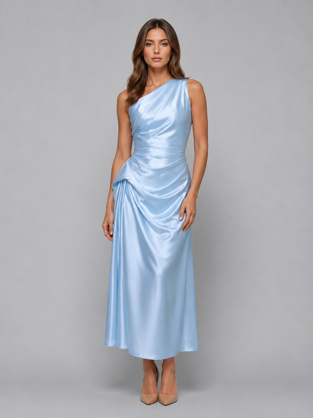 Woman wearing light blue one-shoulder satin midi dress with ruched details and side draping, paired with nude heels