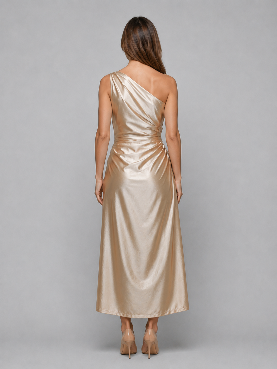 Woman wearing champagne one-shoulder ruched satin midi dress with draped details, shown from behind