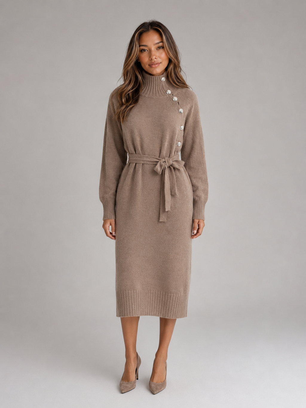 Woman wearing a beige roll neck cotton knit midi dress with buttons and tie belt, styled with nude heels