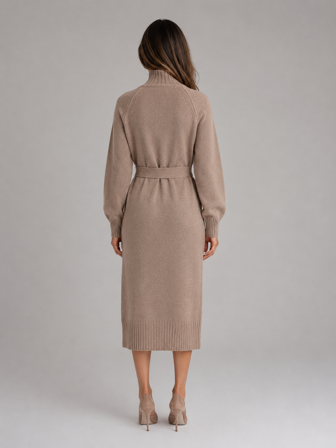 Woman wearing beige roll neck belted midi jumper dress with long sleeves, shown from back view