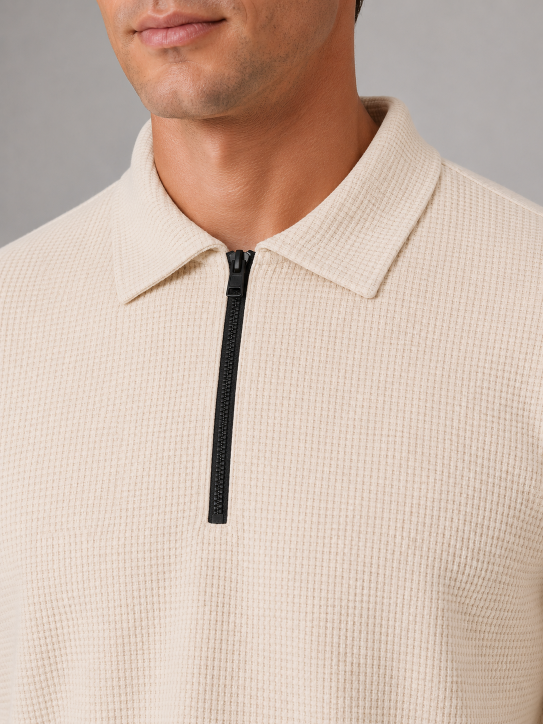 Men's cream textured quarter-zip polo shirt with black zipper and collared neckline