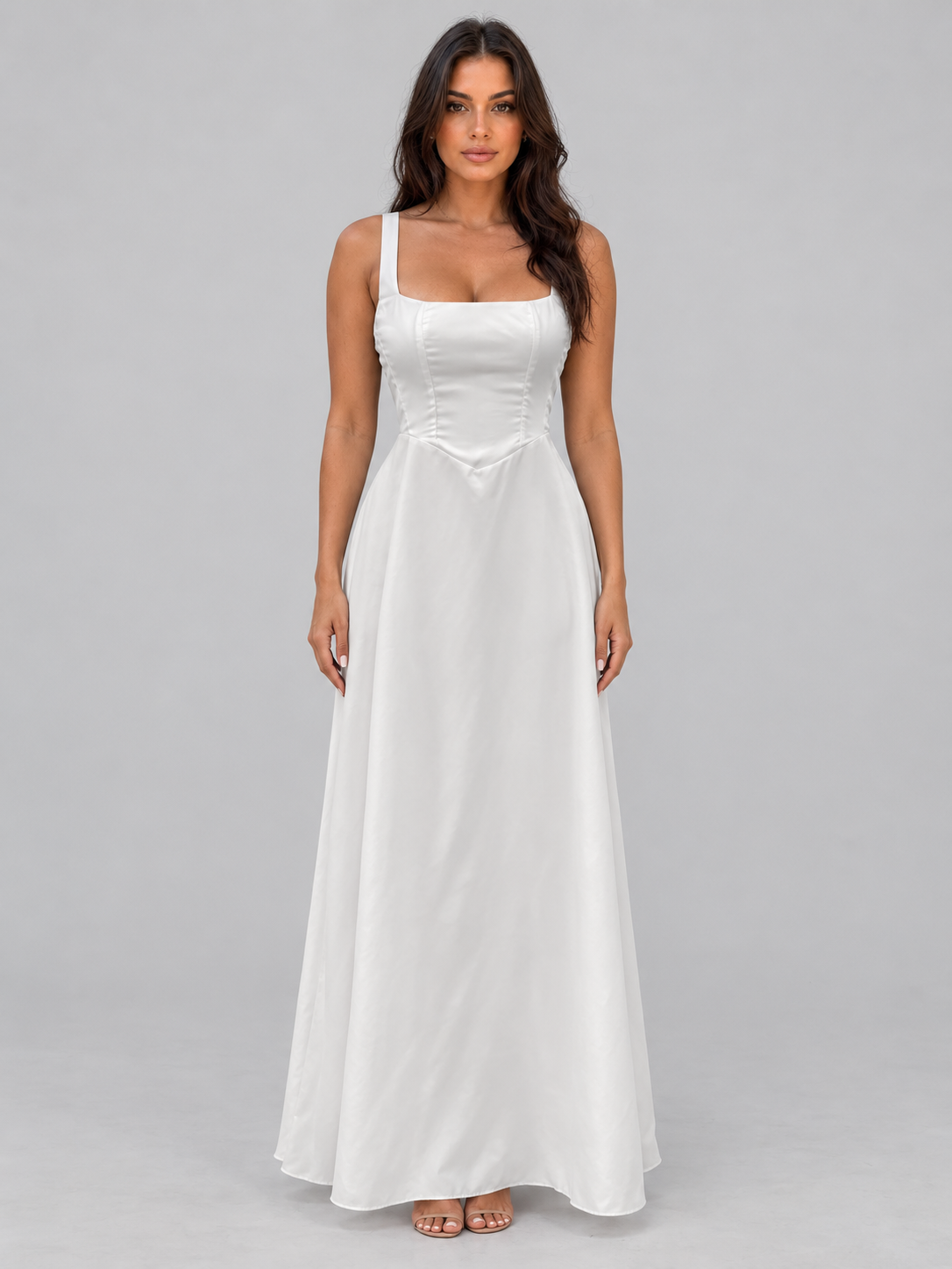 Woman wearing white A-line maxi dress with square neckline and structured bodice, paired with nude sandals