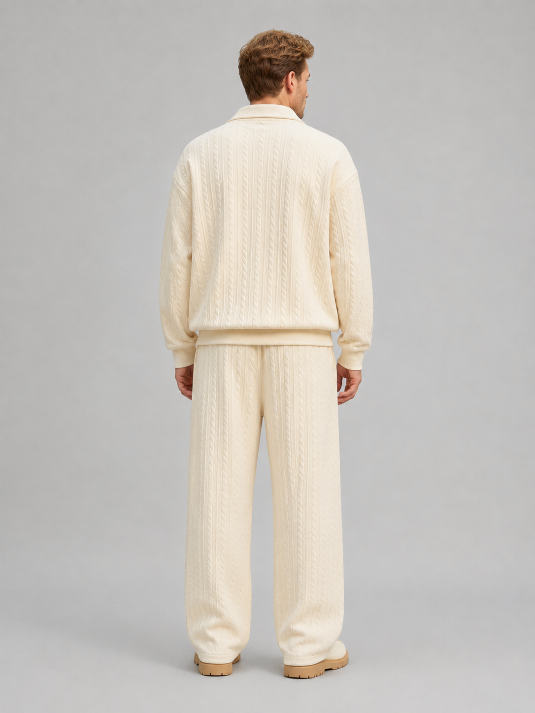 Man wearing cream cable knit collared top and matching wide-leg trousers two-piece set, back view