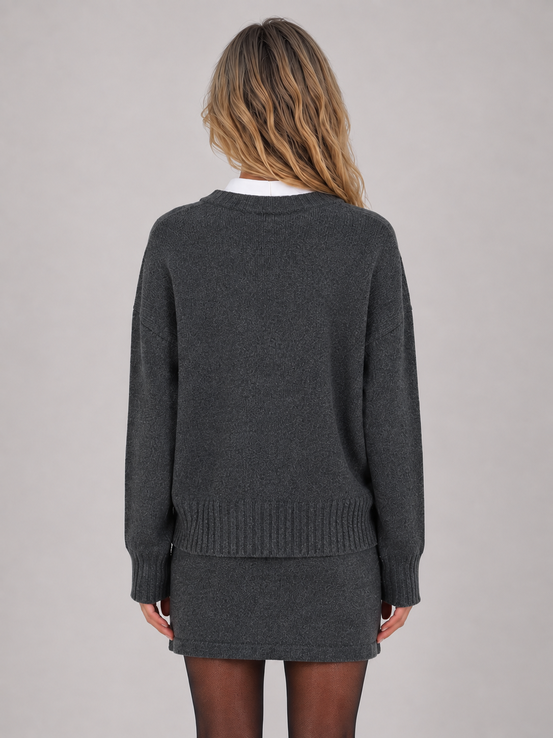 Woman wearing dark gray knitted jumper and mini skirt two-piece set, white collar, back view