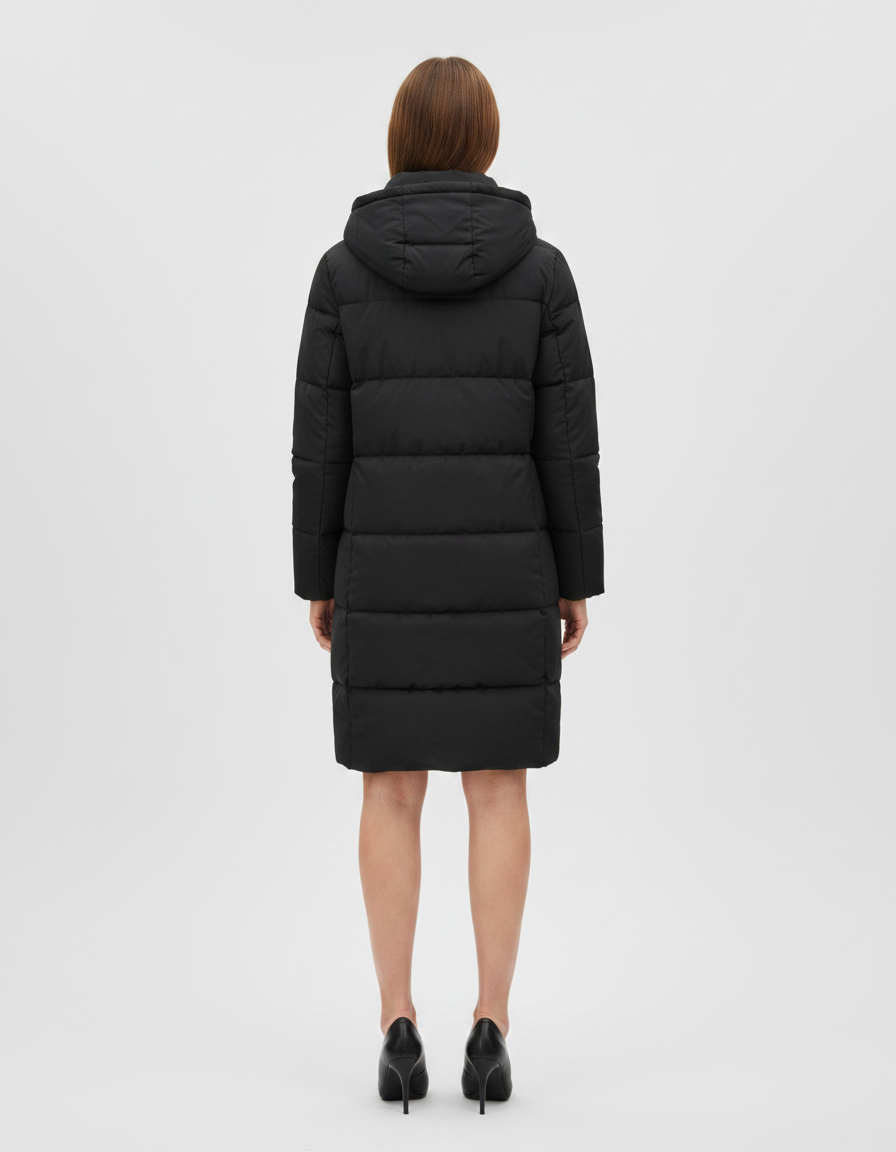 Woman wearing black quilted puffer coat with hood, shown from back view, knee-length style with black heels