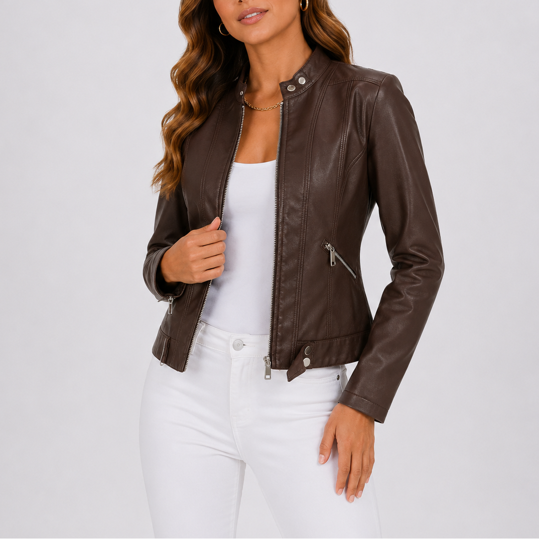 Woman wearing brown leather jacket with zip pockets and white tank top, paired with white pants