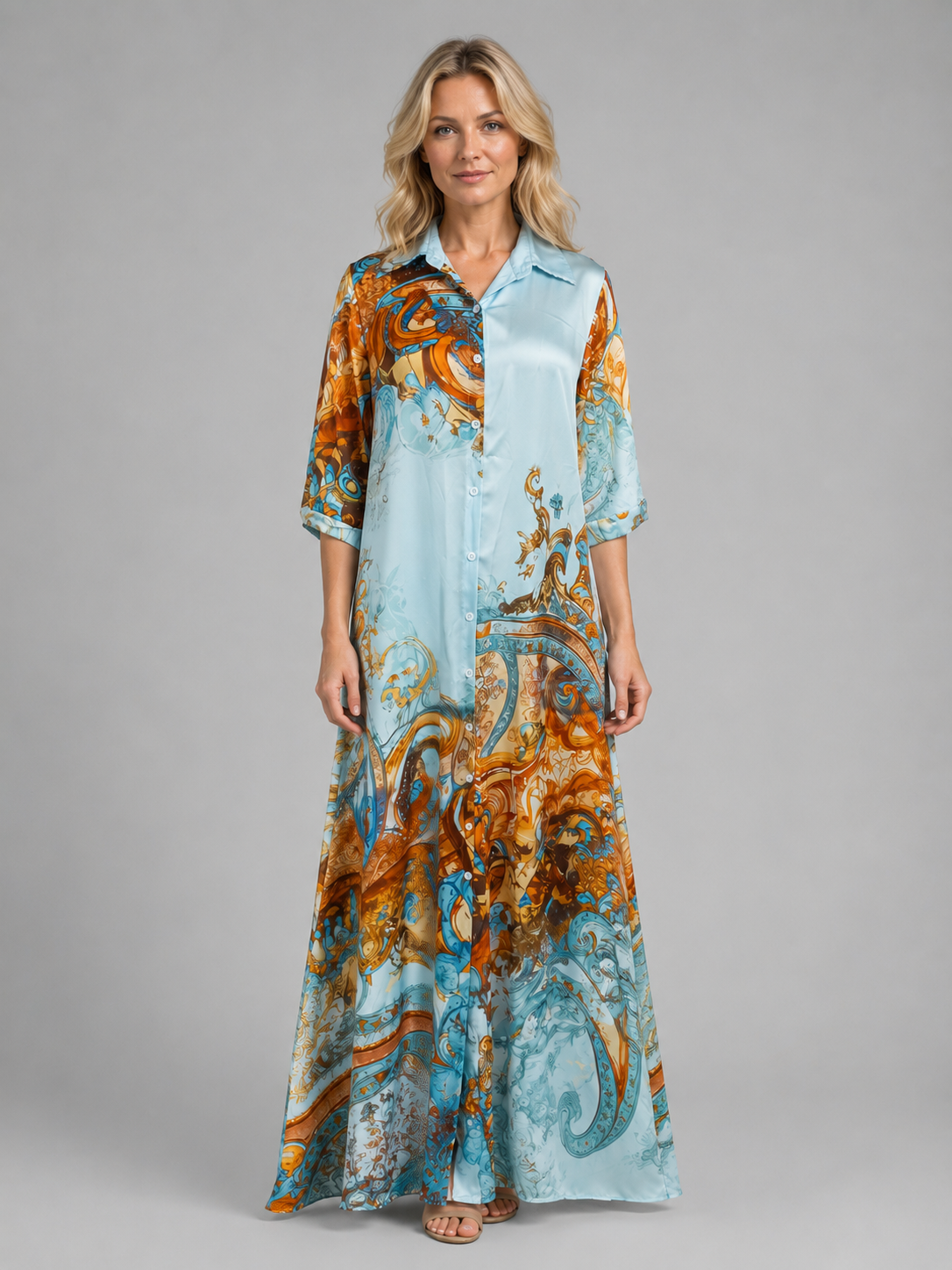 Woman wearing light blue button-front maxi dress with orange and teal baroque print pattern, three-quarter sleeves, full length view