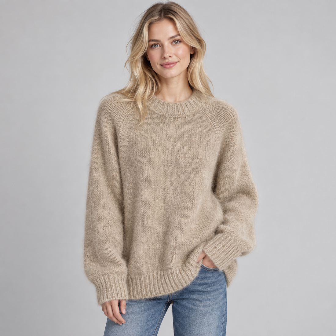 Woman wearing beige round neck fluffy knit jumper with ribbed cuffs and hem, paired with blue jeans
