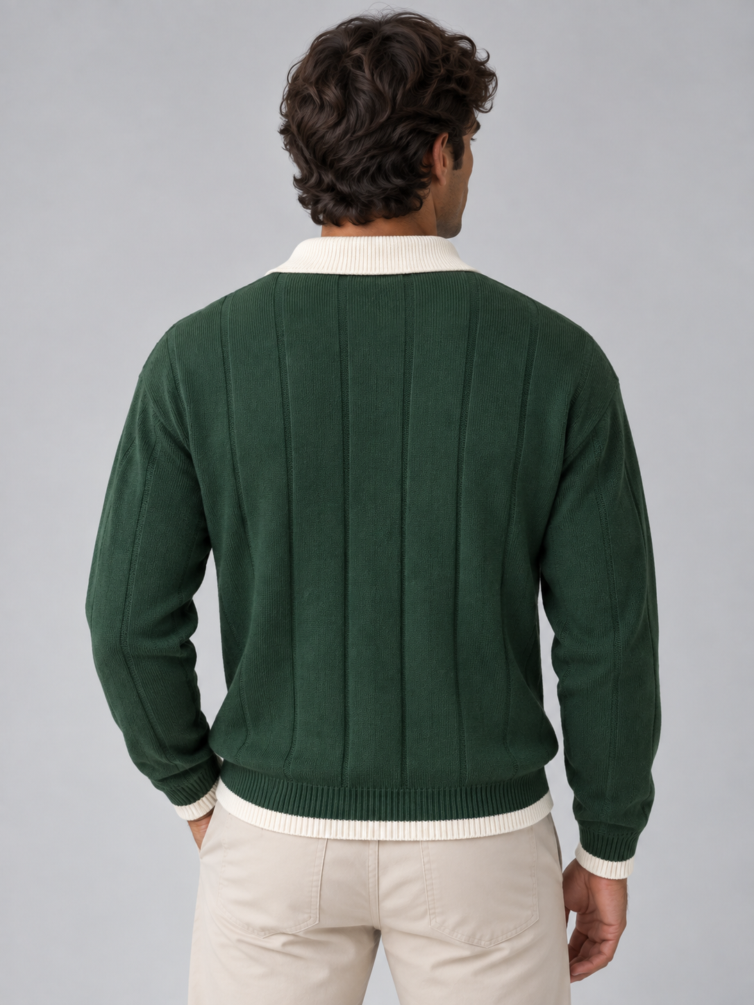 Man wearing green ribbed knit polo jumper with white contrast collar and cuffs, back view