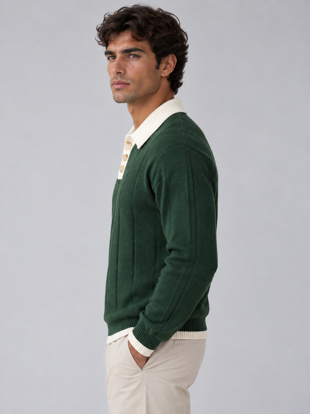 Man wearing green ribbed knit polo jumper with cream contrast collar and buttons, paired with beige chinos