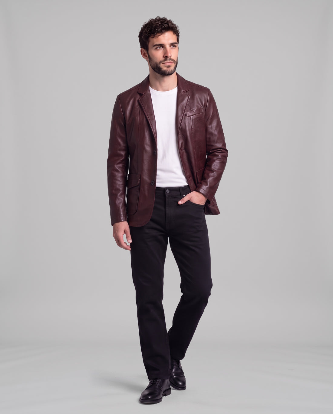 Male model wearing the Soren leather blazer in Burgundy Red with black jeans, full-length view