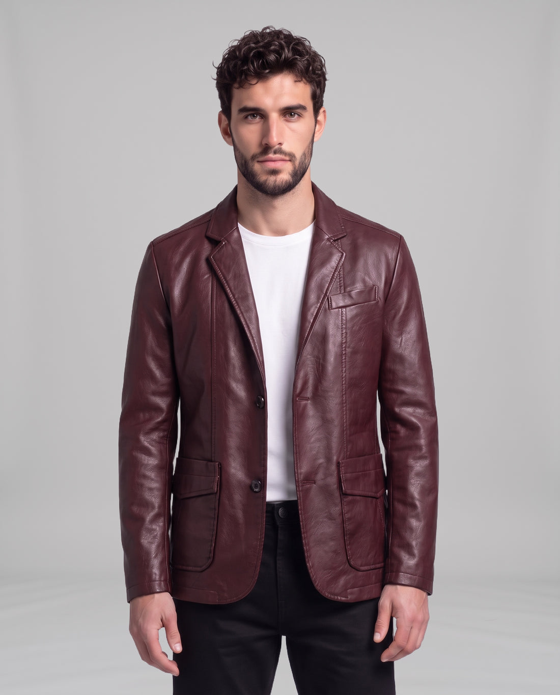 Male model wearing the Soren leather blazer in Burgundy Red over a white t-shirt, front view