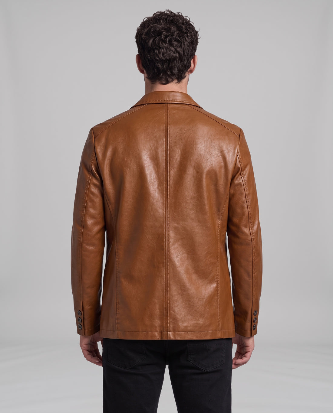 Male model wearing the Soren leather blazer in Cognac Brown, back view showing centre-back seam and tailored side panels