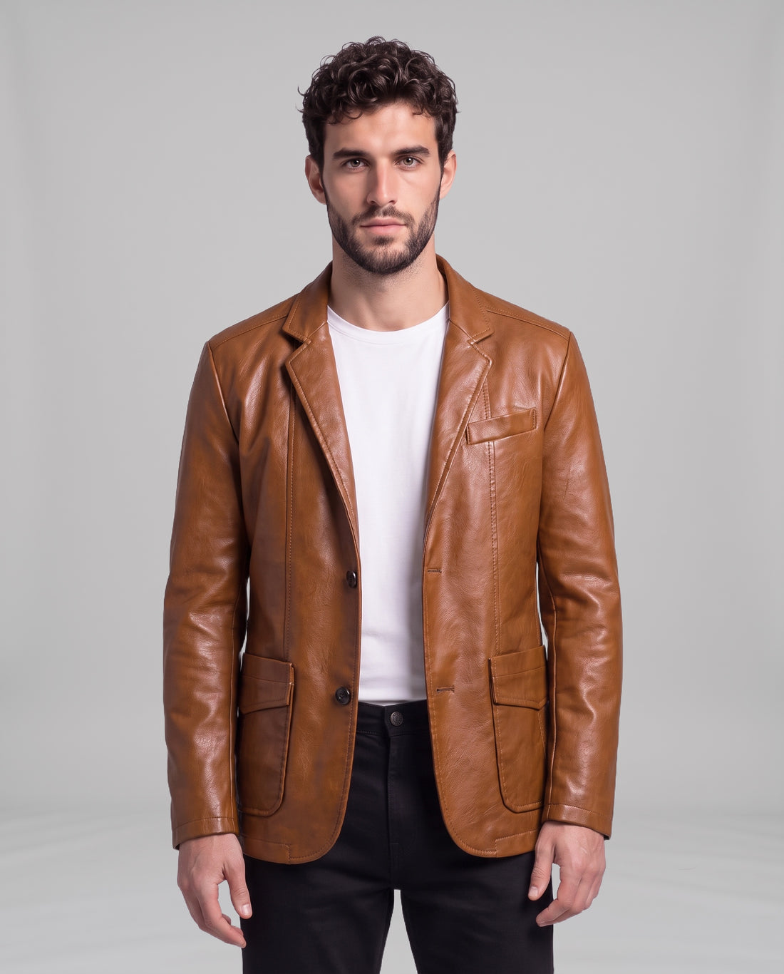 Male model wearing the Soren leather blazer in Cognac Brown over a white t-shirt, front view