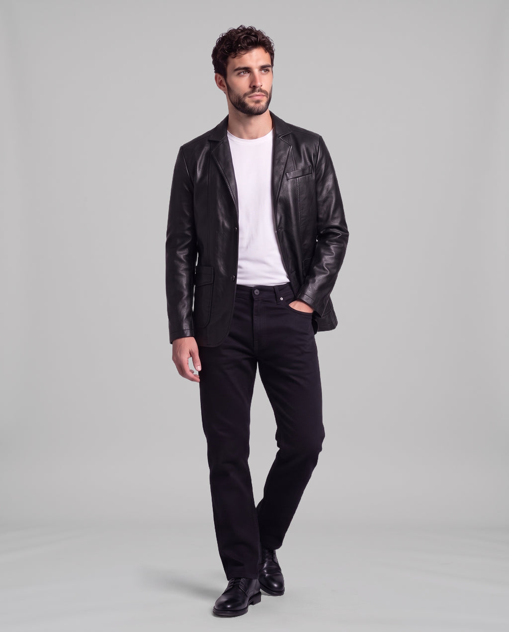 Male model wearing the Soren leather blazer in Obsidian Black with black jeans, full-length view