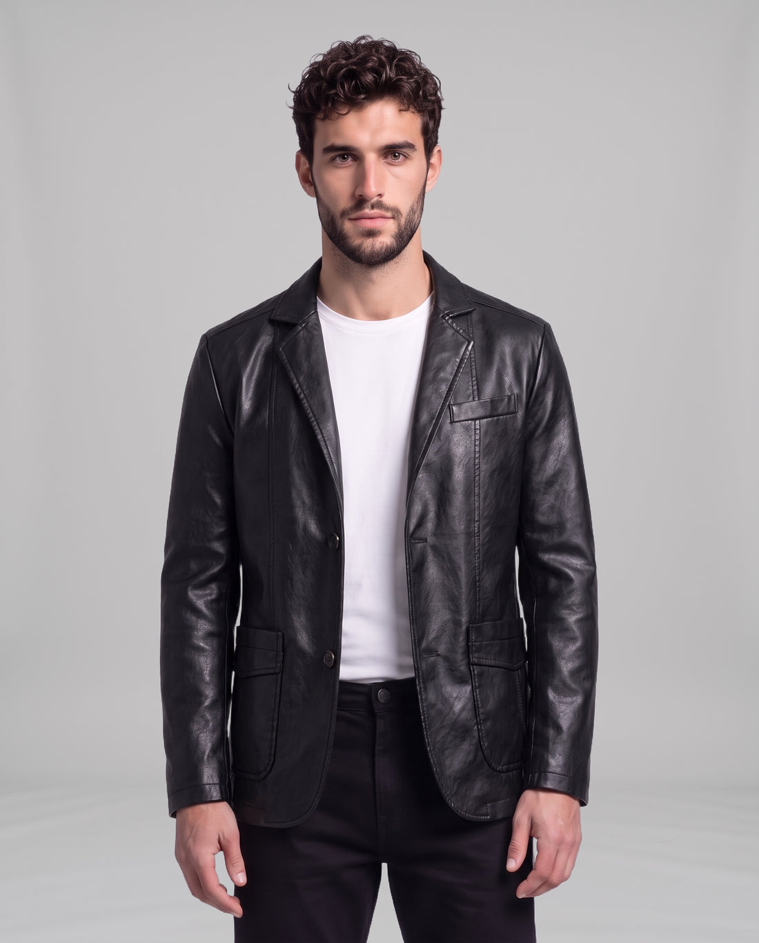 Male model wearing the Soren leather blazer in Obsidian Black over a white t-shirt, front view