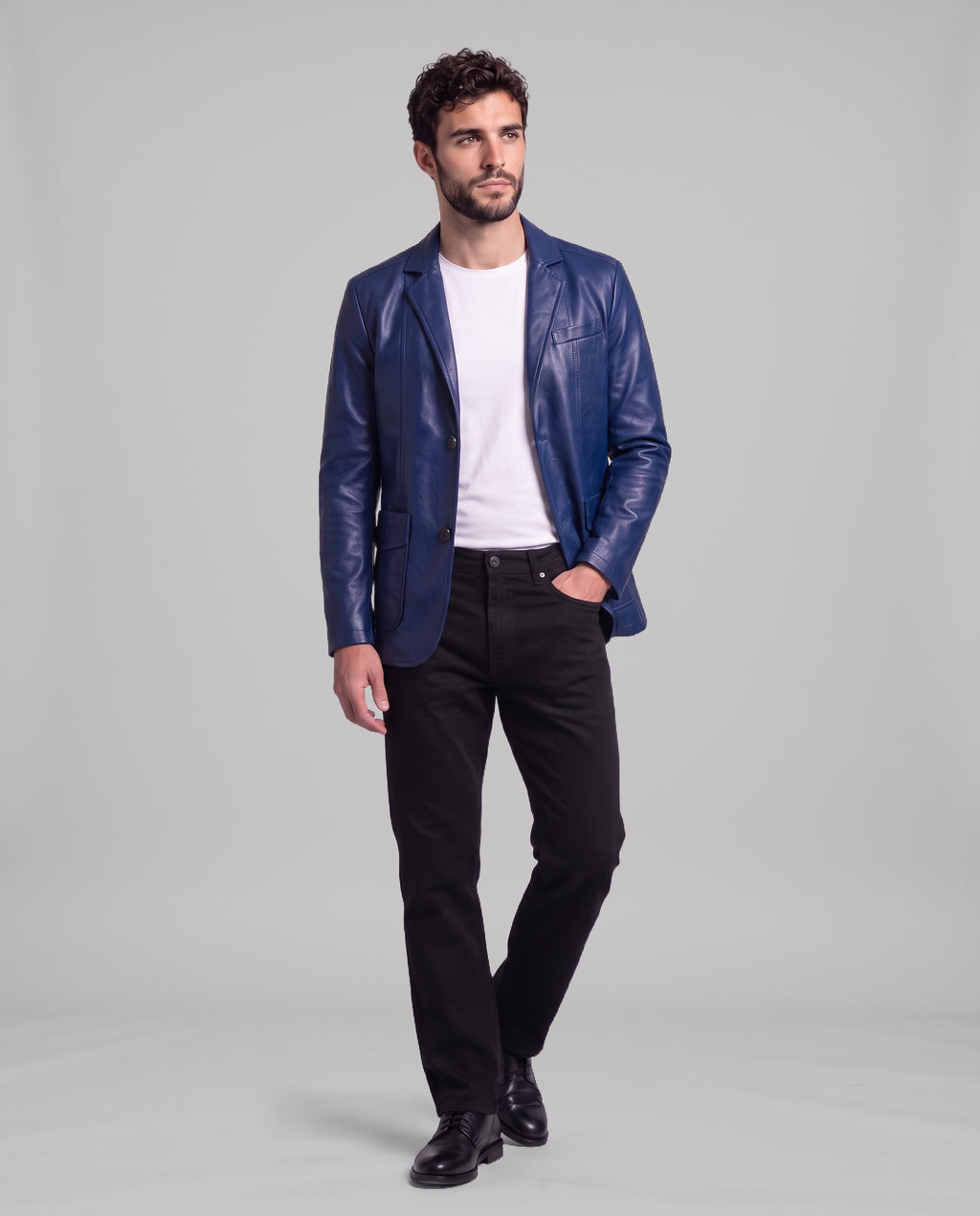 Male model wearing the Soren leather blazer in Sapphire Blue with black jeans, full-length view