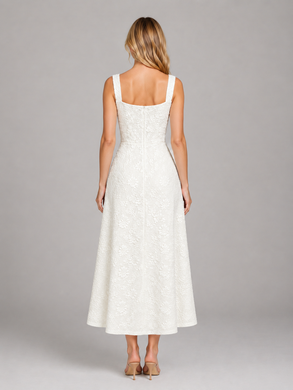 Woman wearing white floral jacquard sleeveless midi dress with scoop neckline, shown from back view with tan heels