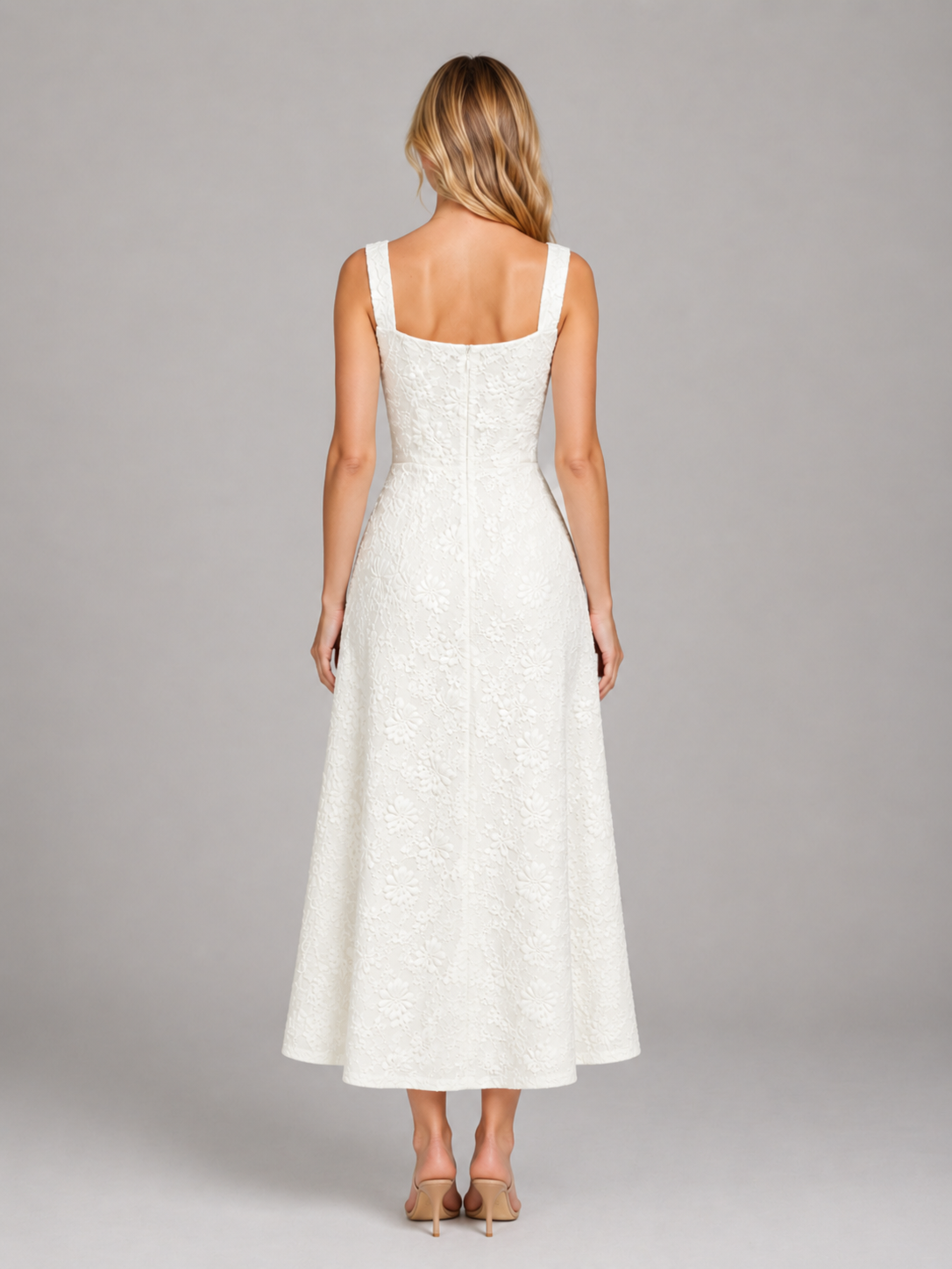 Woman wearing white floral jacquard sleeveless midi dress with scoop neckline, shown from back view with tan heels