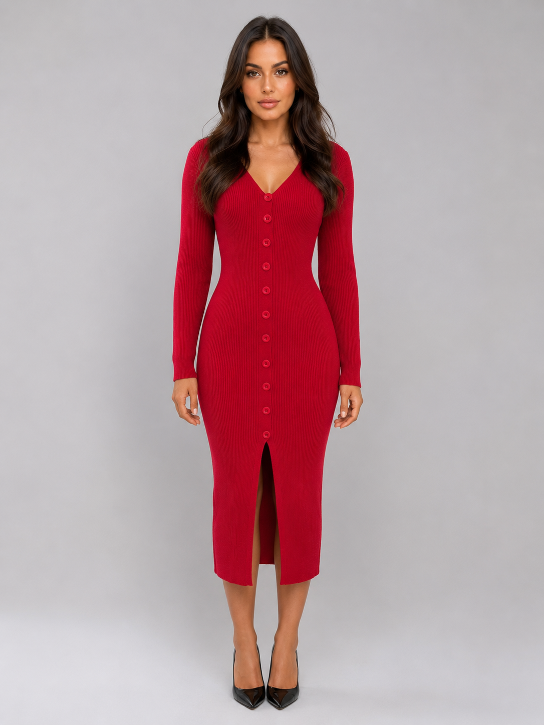 Woman wearing red ribbed knitted midi dress with button front and long sleeves, styled with black pointed-toe heels