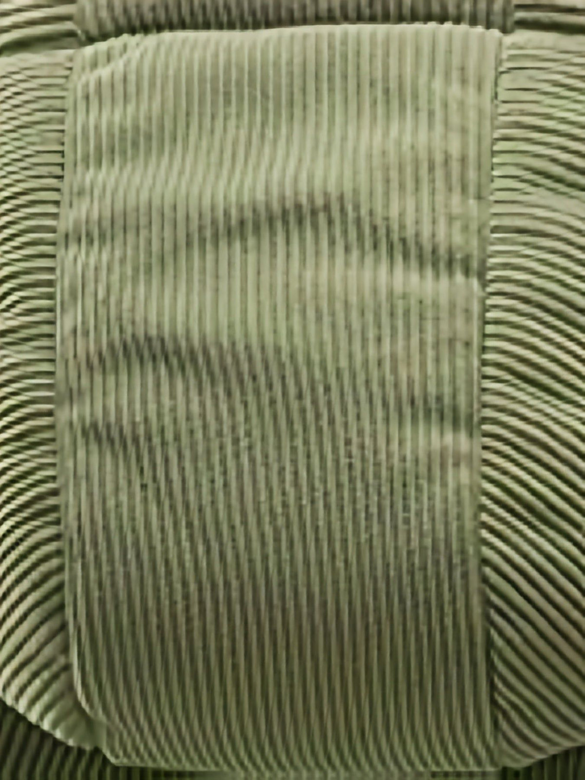 Close-up of olive green quilted fabric texture on Lysander men's oversized puffer jacket with vertical stitching pattern