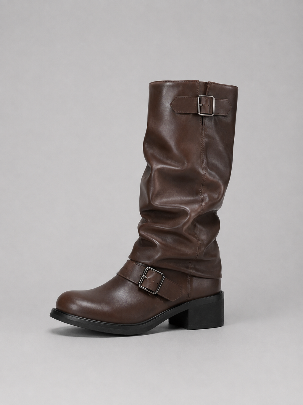 Brown leather knee-high boot with buckle straps and black block heel on gray background