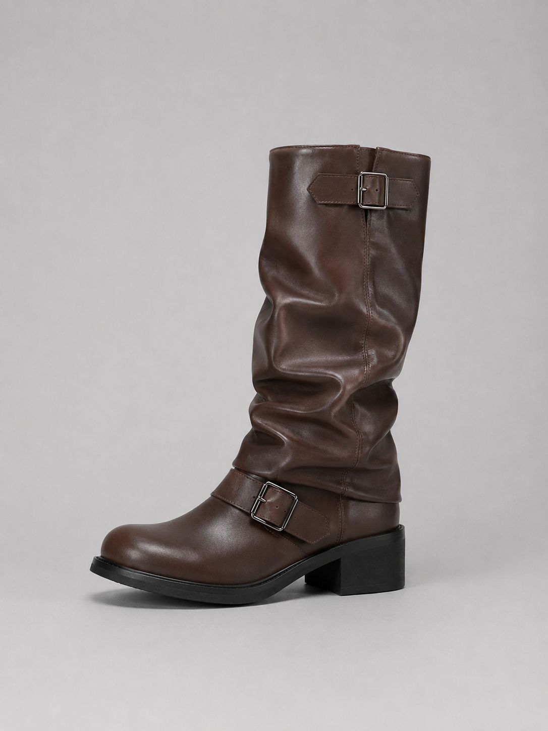 Brown leather knee-high boot with buckle straps and black block heel on gray background