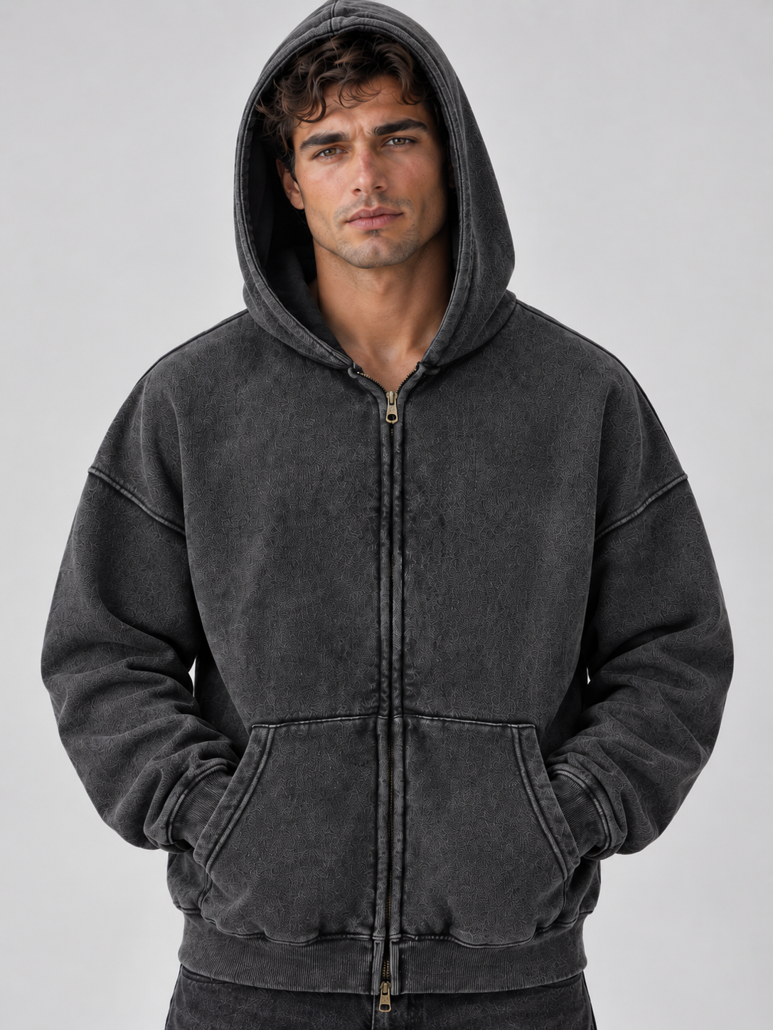 Man wearing charcoal gray washed full zip hoodie with oversized fit and kangaroo pockets