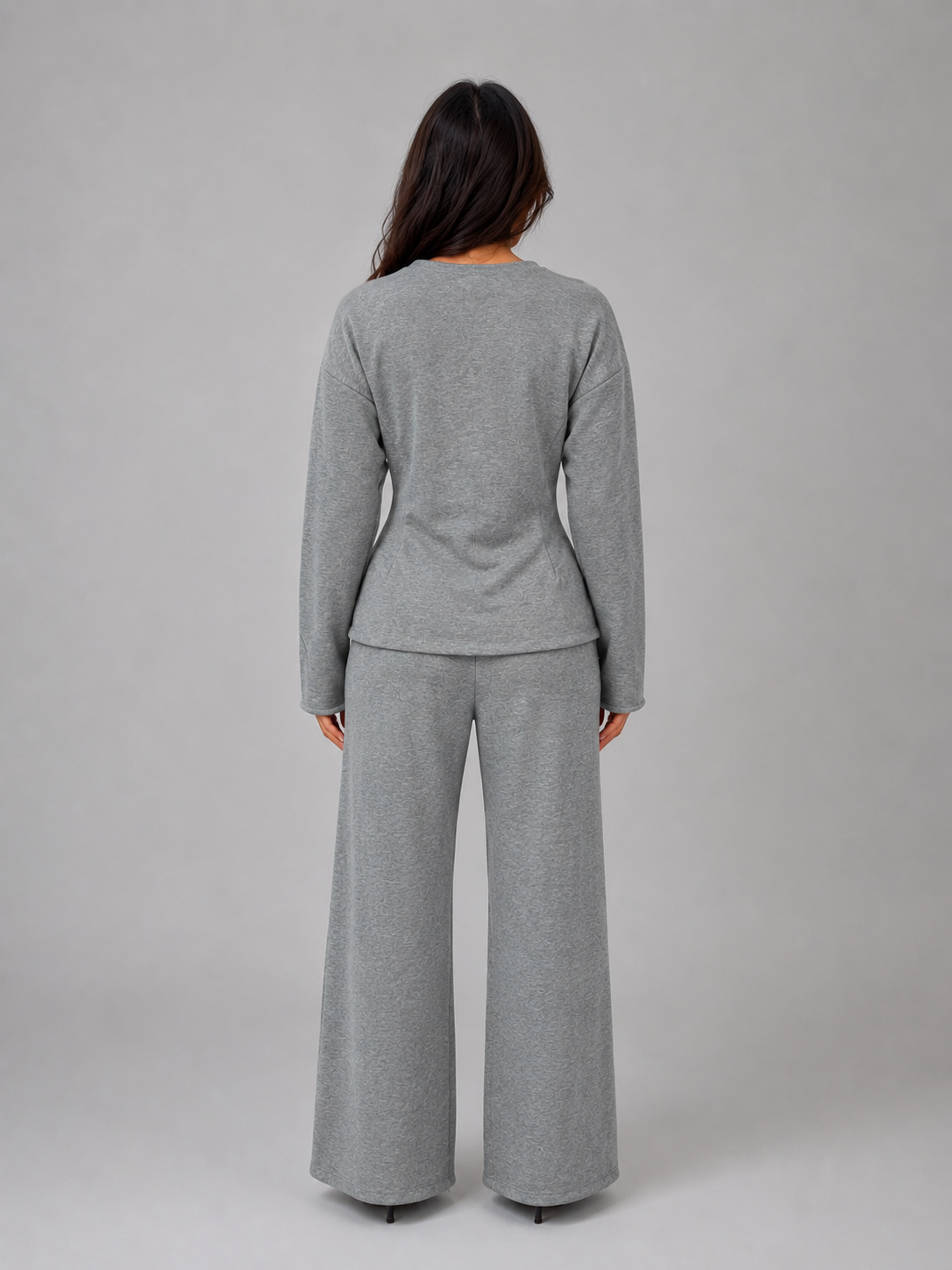 Woman wearing gray fitted long-sleeve top and wide-leg pants co-ord set, back view against neutral background