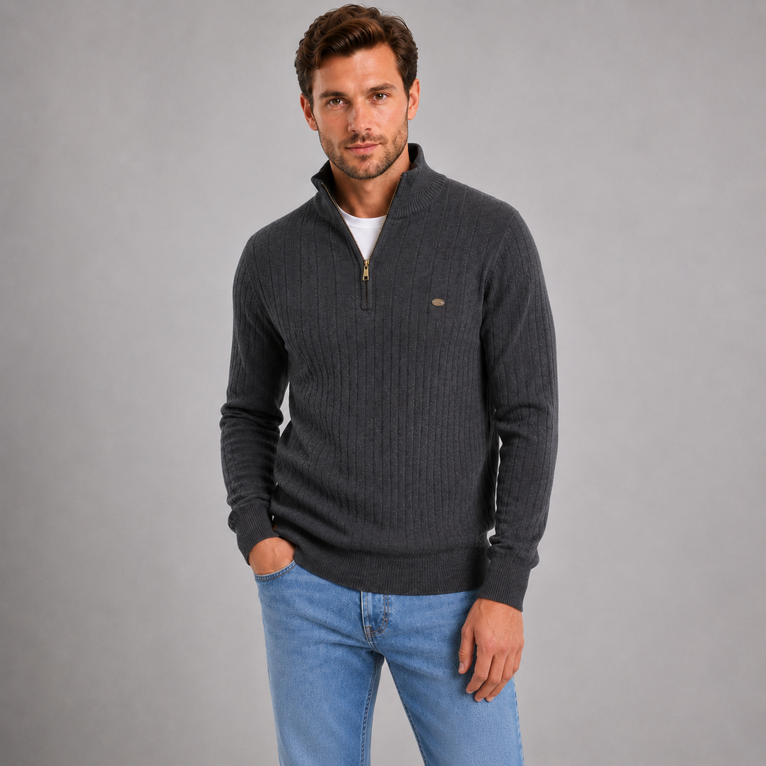 Man wearing dark charcoal ribbed funnel neck quarter zip jumper with white undershirt and blue jeans