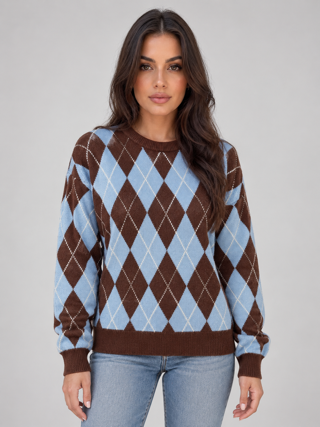 Woman wearing brown and light blue argyle knit sweater with crew neck and long sleeves, paired with light blue jeans