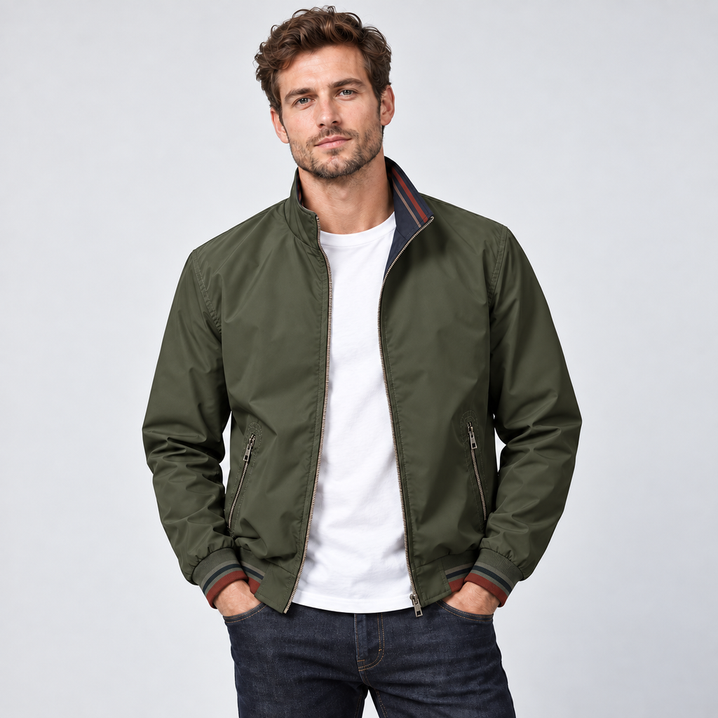 Man wearing olive green reversible zip-up bomber jacket with white t-shirt and dark jeans