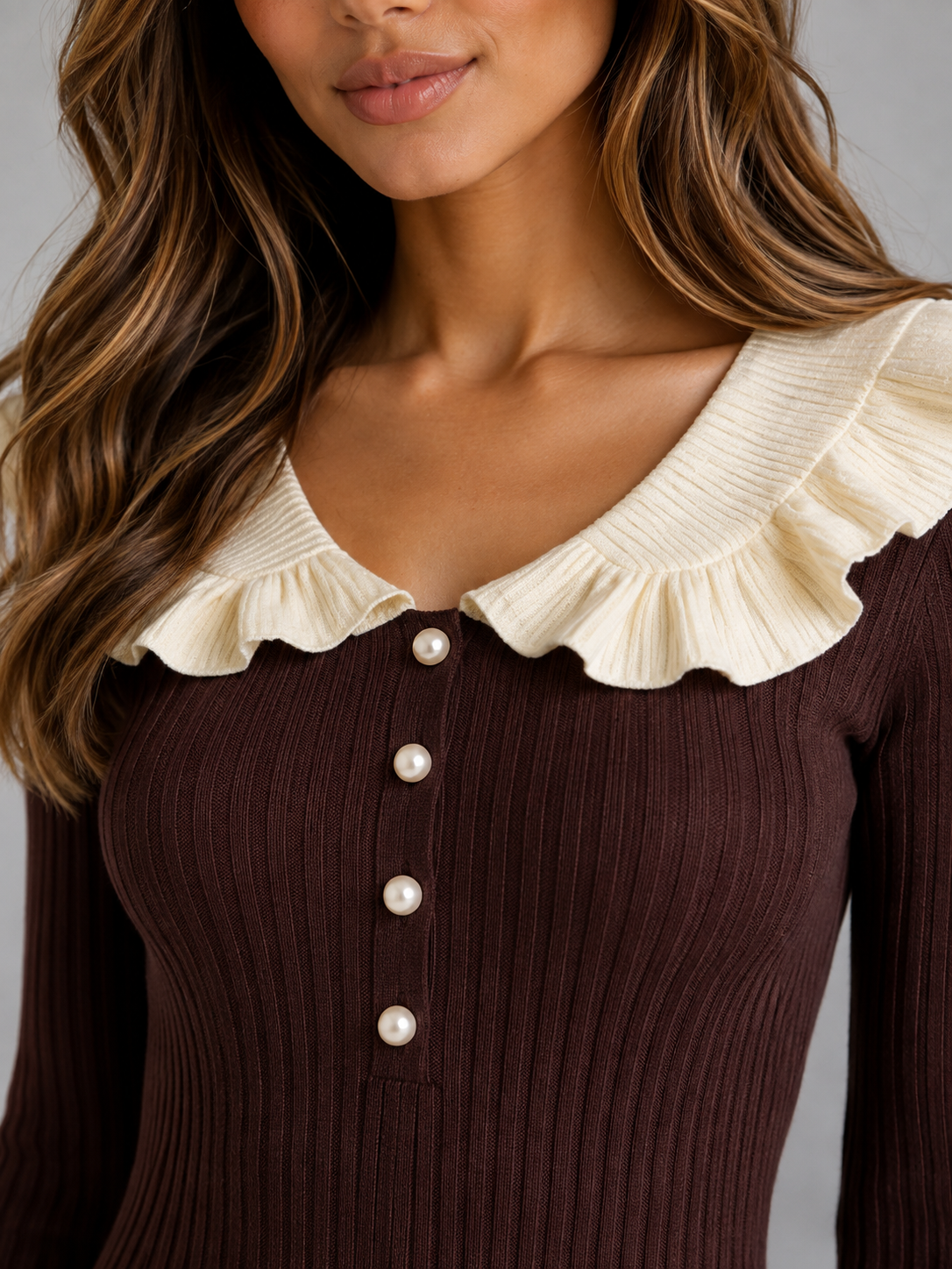 Woman wearing dark brown ribbed knit midi dress with cream pleated ruffle collar and pearl button front