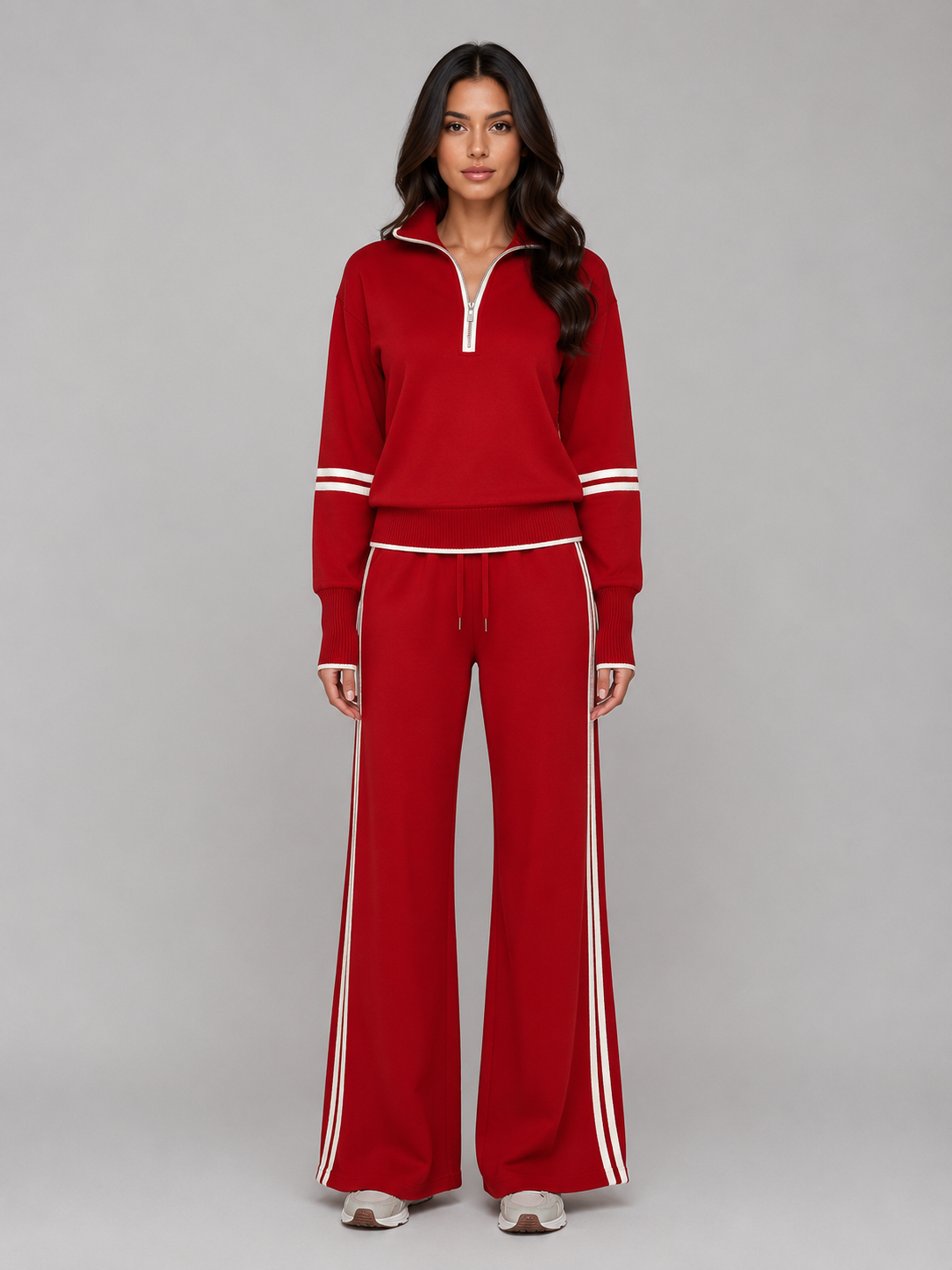 Woman wearing red relaxed wide leg tracksuit with white stripes, half zip sweatshirt and matching lounge pants
