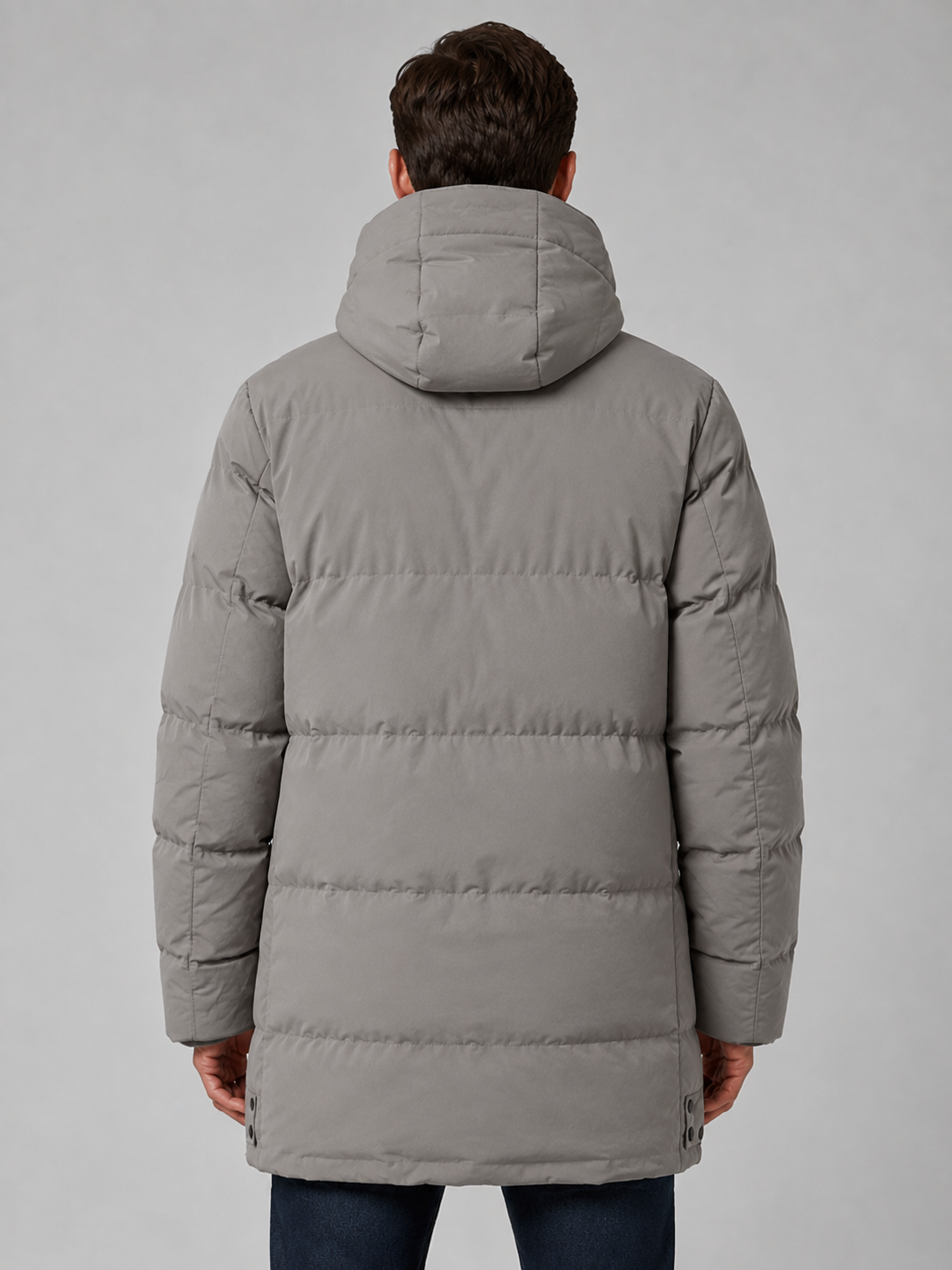 Man wearing gray longline padded winter parka jacket with hood, shown from back view against white background