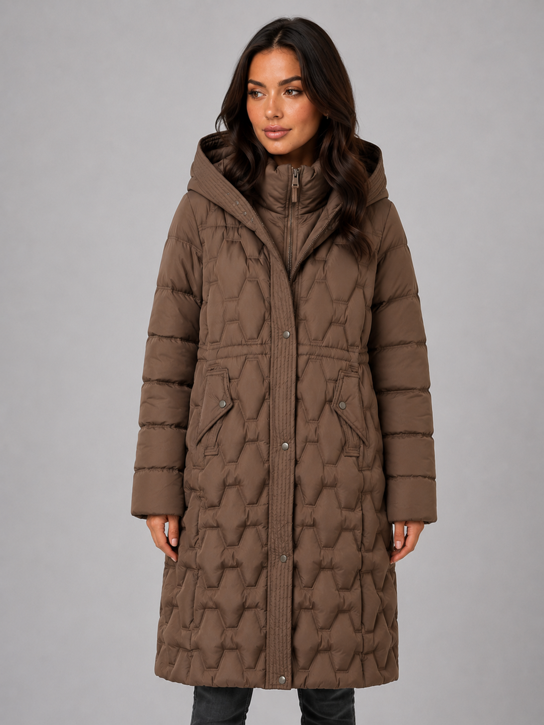Woman wearing brown hooded quilted long puffer coat with diamond pattern and front pockets