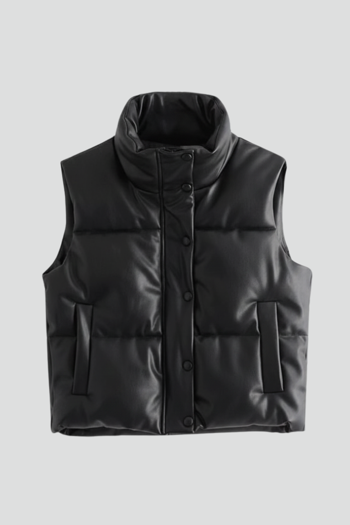 Black sleeveless puffer vest with quilted paneling, standing collar, front snap buttons, and side pockets