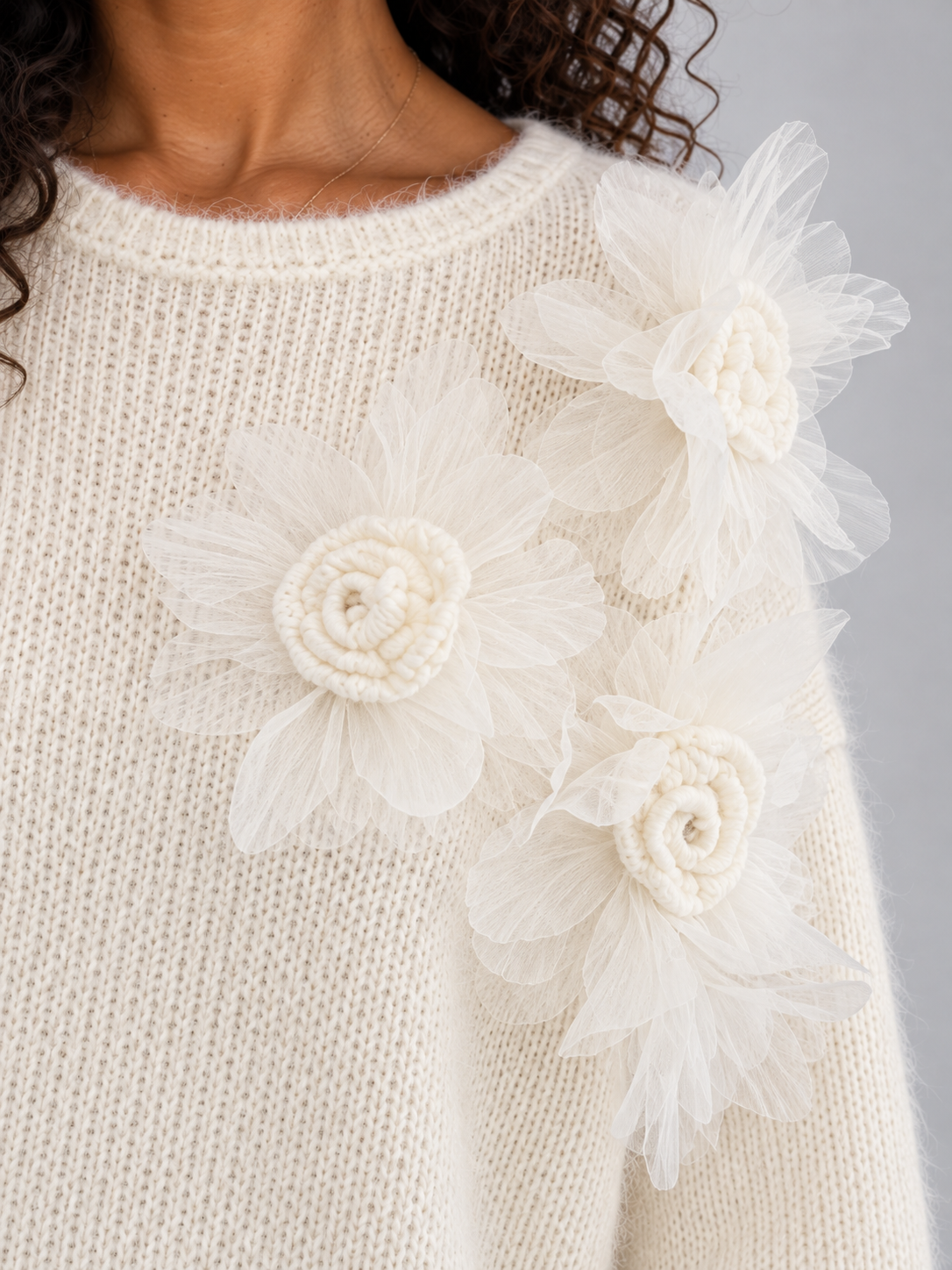 Women's cream knit sweater with crew neckline and white tulle 3D floral embellishments on chest