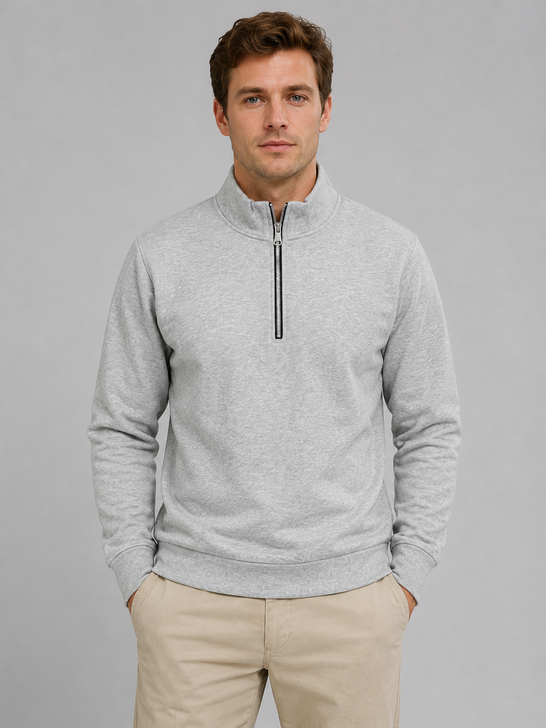Men's gray high neck half-zip pullover sweatshirt worn with beige pants, front view on neutral background