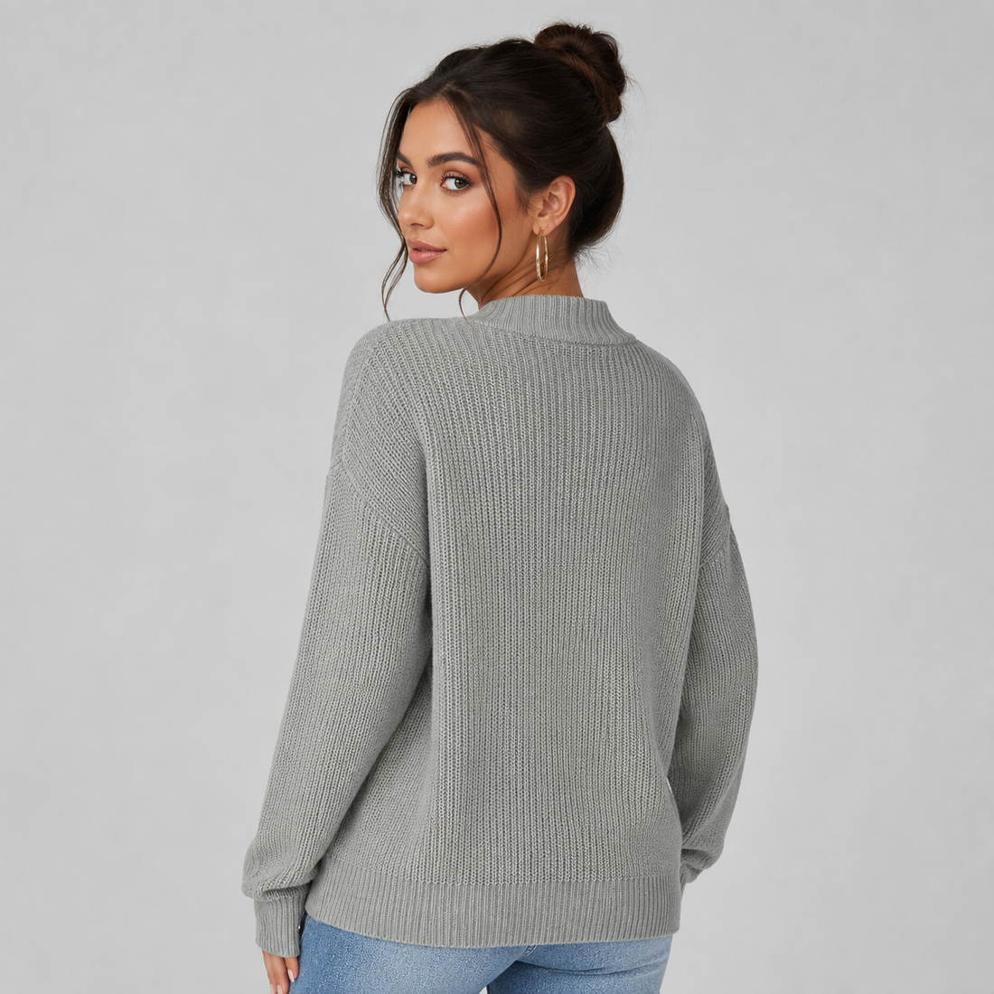 Woman wearing gray ribbed v-neck button front cardigan with long sleeves, styled with jeans, viewed from back