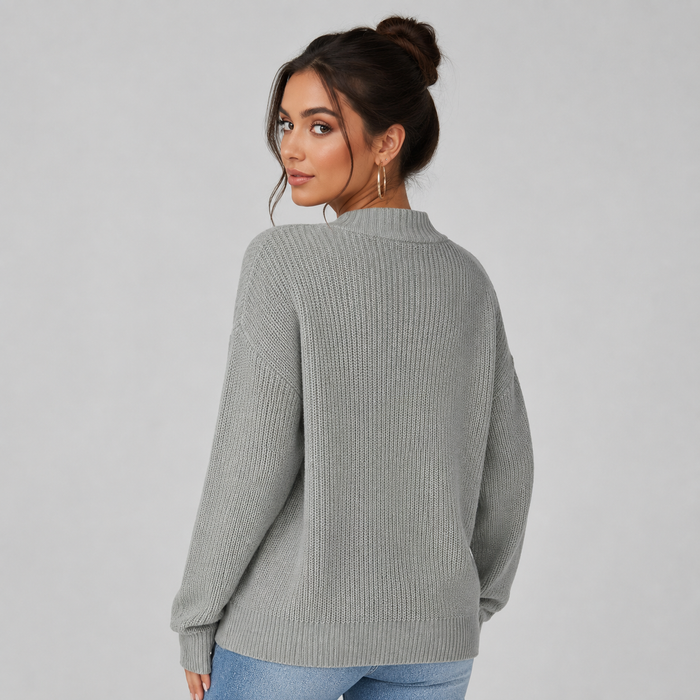 Woman wearing gray ribbed v-neck button front cardigan with long sleeves, styled with jeans, viewed from back