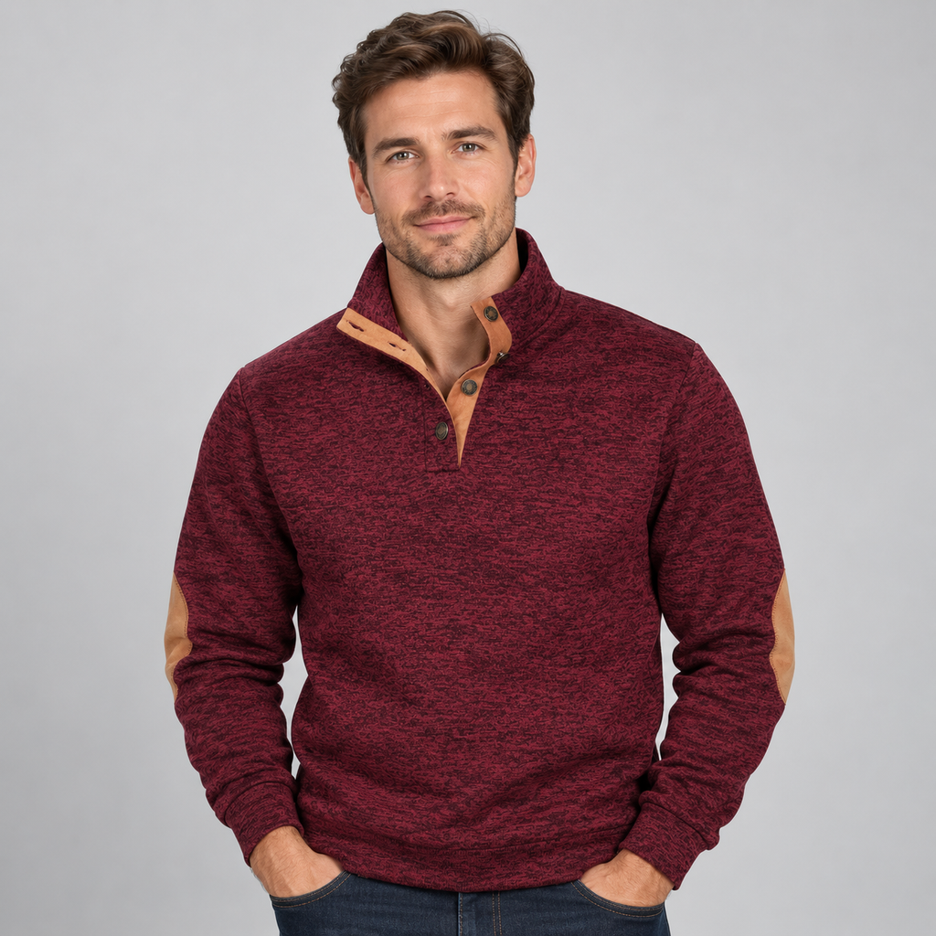 Man wearing burgundy quarter button stand collar jumper with tan elbow patches and brown buttons