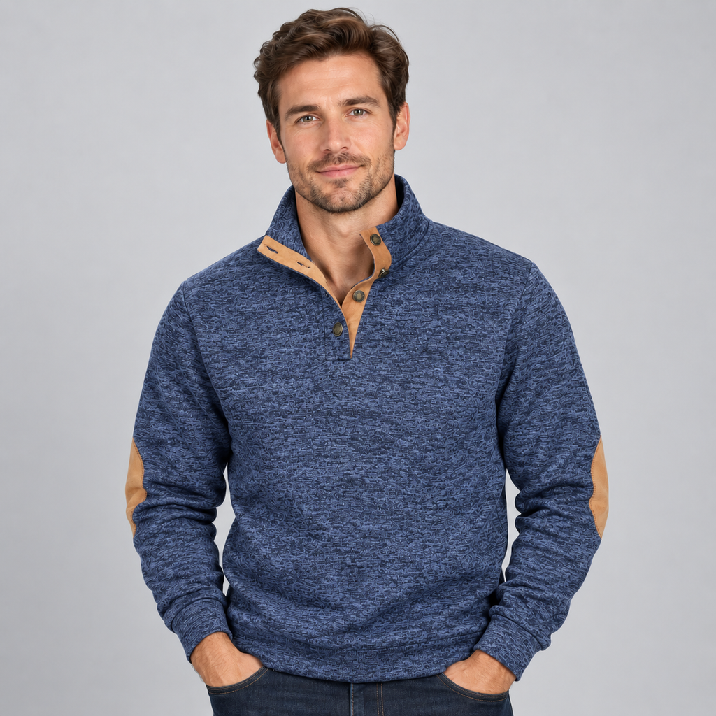 Man wearing blue heathered quarter button stand collar jumper with tan elbow patches and brown buttons