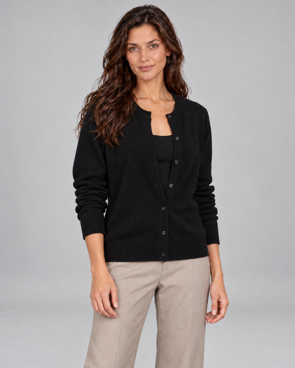 Black women's Merino cardigan, front view on Andrea, grey studio