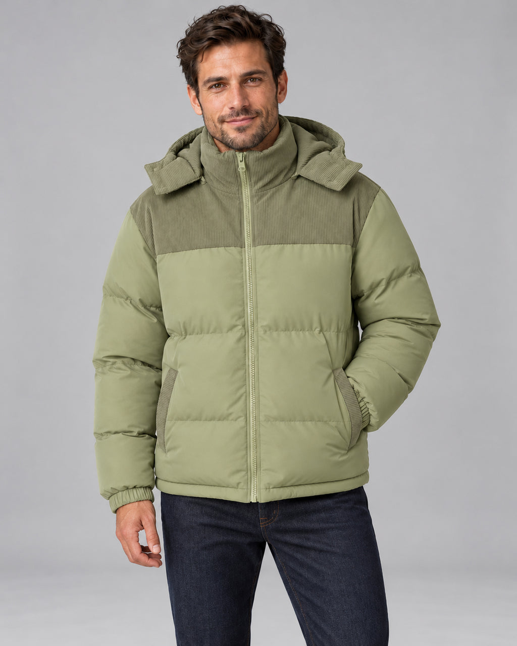 Men's sage green hooded corduroy puffer jacket, front view with one hand in jacket pocket