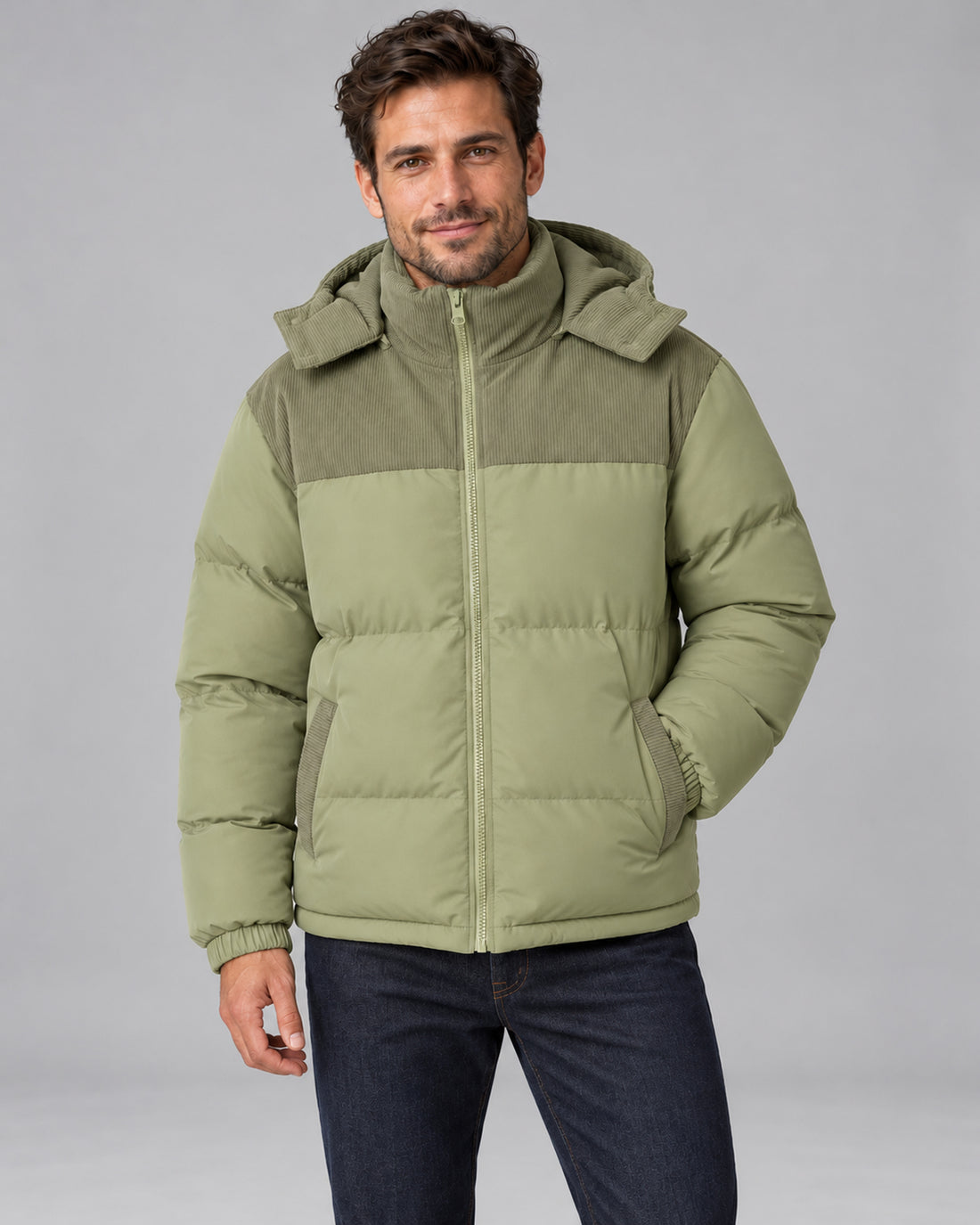 Men's sage green hooded corduroy puffer jacket, front view with one hand in jacket pocket